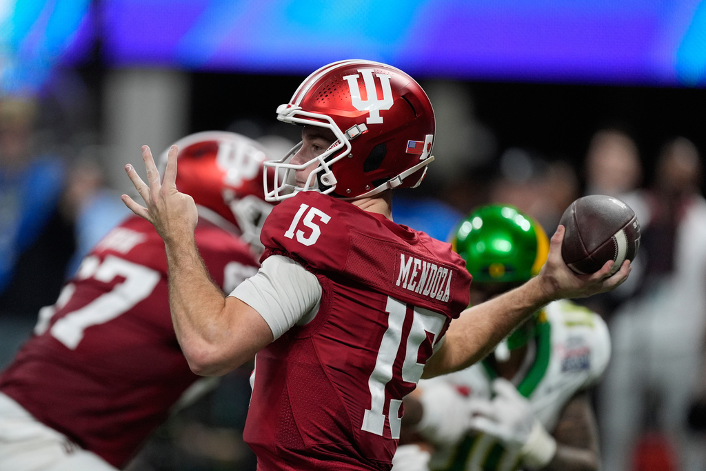 Indiana quarterback Fernando Mendoza (15) passes during the second half of the Peach Bowl NCAA college football playoff semifinal against Oregon, Friday, Jan. 9, 2026, in Atlanta. (AP Photo/Mike Stewart)