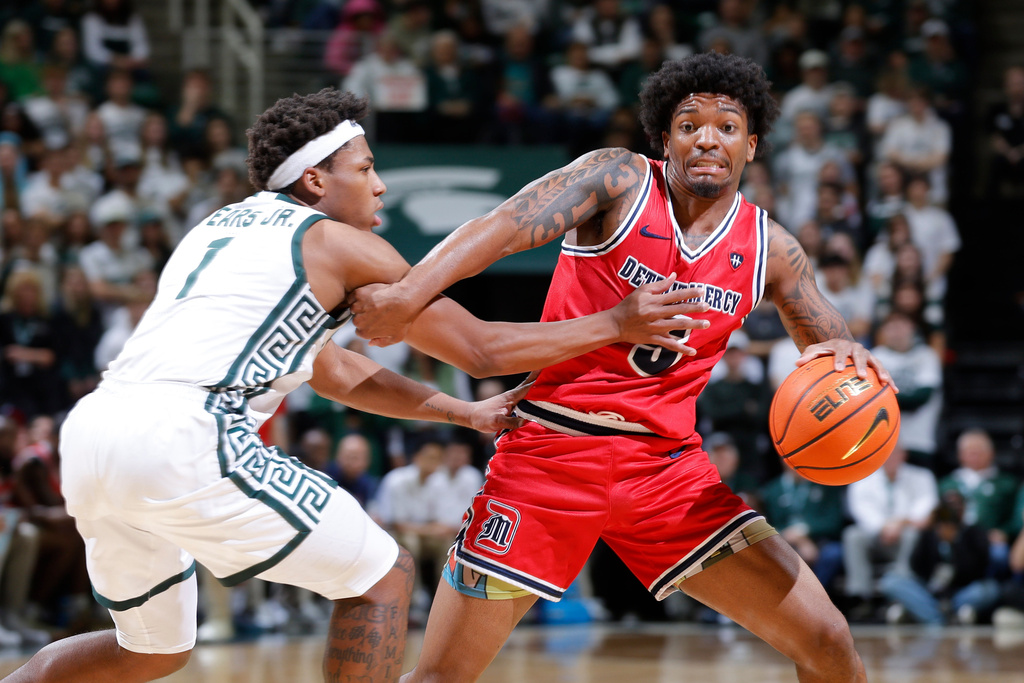 Detroit Mercy guard Orlando Lovejoy, right, drives and a draws a foul against Michigan State guard Jeremy Fears Jr. (1) during the first half of an NCAA college basketball game, Friday, Nov. 21, 2025, in East Lansing, Mich. (AP Photo/Al Goldis)