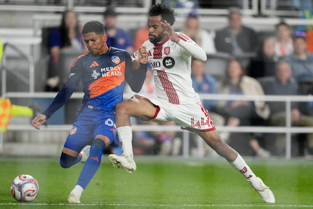 FC Cincinnati forward Ender Echenique (66) and Toronto FC defender Raheem Edwards (44) battle for the ball during the first half of an MLS soccer match in Cincinnati, Sunday, March 8, 2026. (AP Photo/Carolyn Kaster)