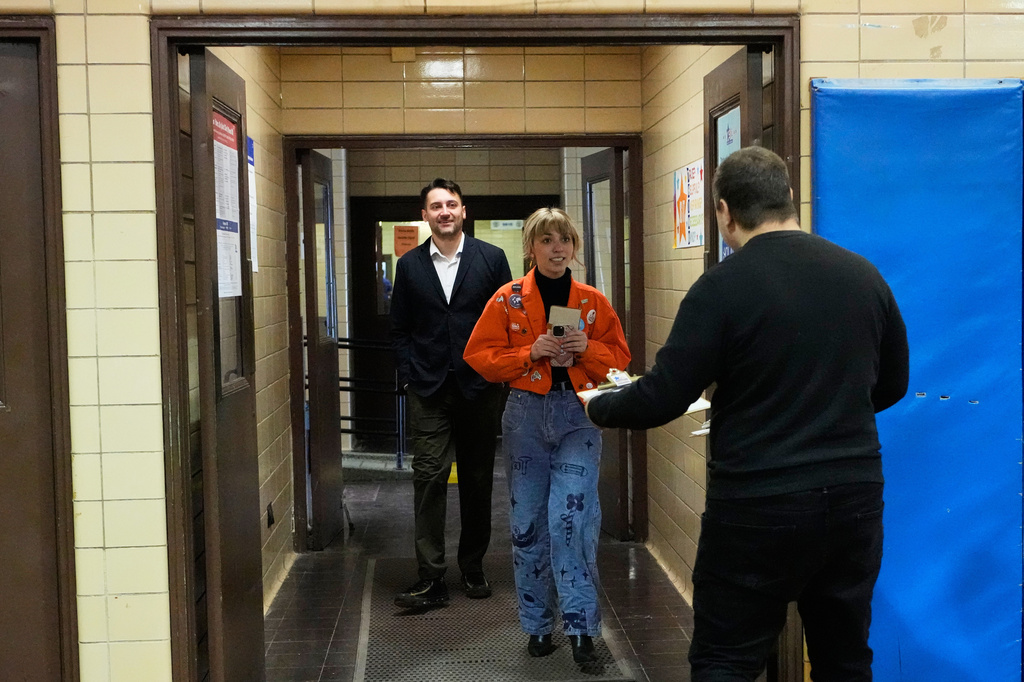 FILE - The Onion CEO Ben Collins, left, walks to vote with his girlfriend and Democratic candidate for Congress, Kat Abughazaleh, center, on Election Day at Chicago Park District Loyola field house in Chicago, Tuesday, March 17, 2026. (AP Photo/Nam Y. Huh, File)