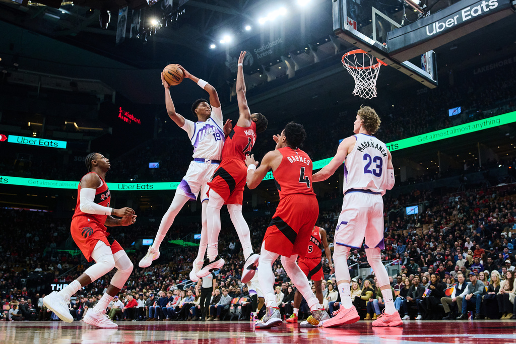 Utah Jazz's Ace Bailey (19) is blocked on a drive to the net by Toronto Raptors' Collin Murray-Boyles (12) during the first half of an NBA basketball game in Toronto, Sunday, Feb. 1, 2026. (Sammy Kogan/The Canadian Press via AP)
