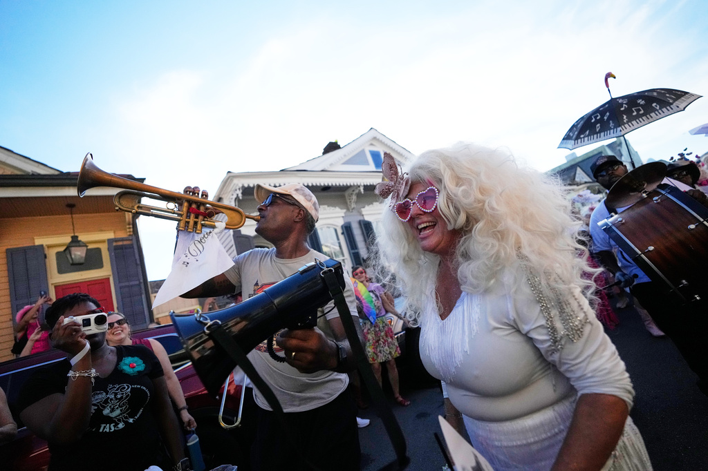 Members of the Krewe of Dolly lead a second line parade in commemoration of the life of Dolly Parton through the French Quarter Friday, Sept. 25, 2026, in New Orleans. (AP Photo/Gerald Herbert)