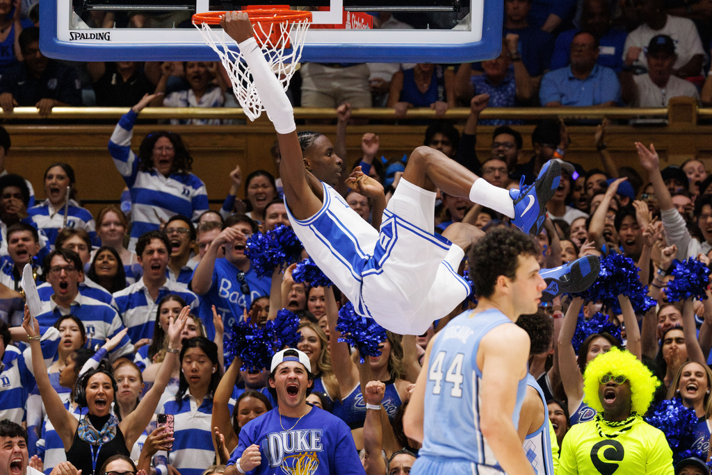 Duke's Dame Sarr (7) dunks during the first half of an NCAA college basketball game against North Carolina in Durham, N.C., Saturday, March 7, 2026. (AP Photo/Ben McKeown)