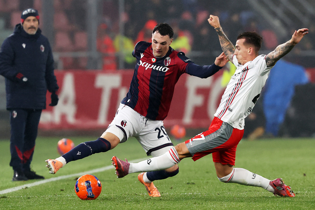 Cremonese's Jari Vandeputte, right, and Bologna's Nadir Zortea, left, challenge for the ball during the Serie A soccer match between FC Bologna and US Cremonese in Bologna, Italy, Monday, Dec. 1, 2025. (Gianni Santandrea/LaPresse via AP)