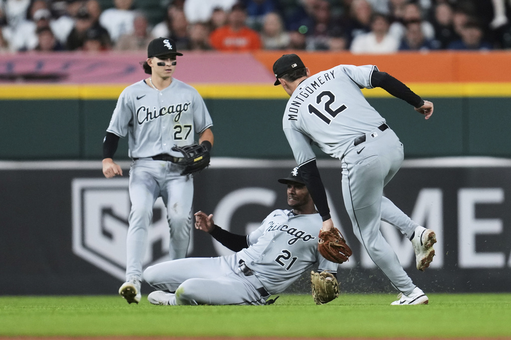 Chicago White Sox center fielder Michael A. Taylor (21) catches a Detroit Tigers' Wenceel Pérez fly ball as Colson Montgomery (12) and Brooks Baldwin (27) look on during the seventh inning of a baseball game Saturday, Sept. 6, 2025, in Detroit. (AP Photo/Paul Sancya)
