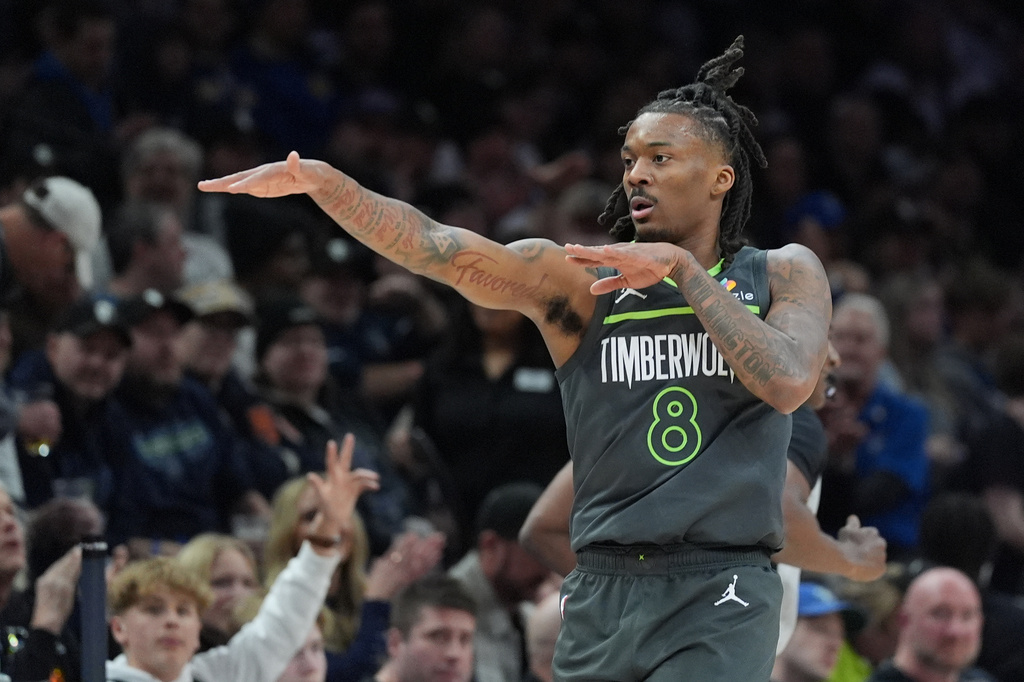 Minnesota Timberwolves guard Bones Hyland gestures after making a 3-point basket during the first half of an NBA basketball game against the Golden State Warriors, Monday, Jan. 26, 2026, in Minneapolis. (AP Photo/Abbie Parr)