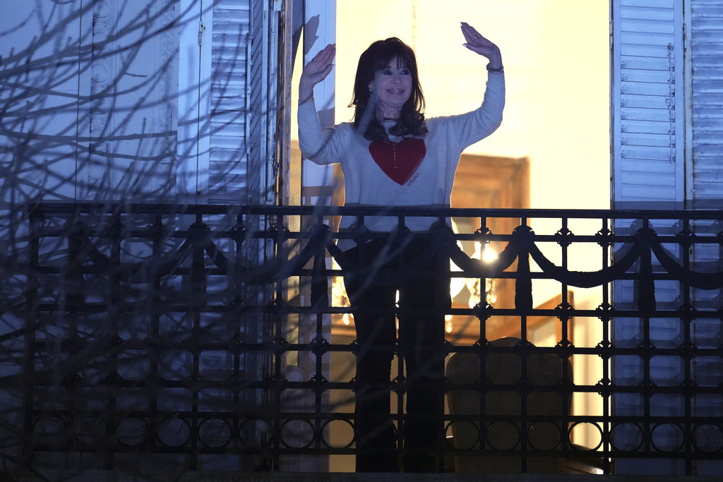 Former President Cristina Fernandez waves to supporters from the balcony of her home where she is serving a six-year house arrest sentence for corruption, after legislative provincial election polls closed, in Buenos Aires, Argentina, Sunday, Sept. 7, 2025. (AP Photo/Natacha Pisarenko)