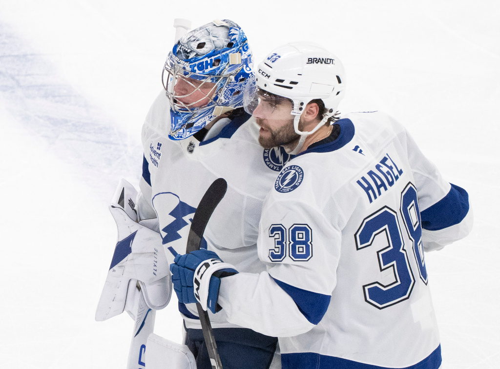 Tampa Bay Lightning's Brandon Hagel (38) congratulates goaltender Andrei Vasilevskiy, left, after their team defeated the Montreal Canadiens in overtime of Game 6 in the first round of an NHL hockey Stanley Cup playoff series in Montreal, Friday, May 1, 2026. (Christinne Muschi/The Canadian Press via AP)