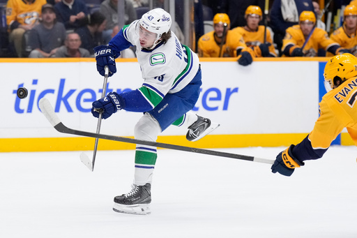 Vancouver Canucks defenseman Quinn Hughes (43) shoots the puck during the first period of an NHL hockey game against the Nashville Predators, Thursday, Oct. 23, 2025, in Nashville, Tenn. (AP Photo/George Walker IV) Vancouver Canucks defenseman Quinn Hughes (43) shoots the puck during the first period of an NHL hockey game against the Nashville Predators, Thursday, Oct. 23, 2025, in Nashville, Tenn. (AP Photo/George Walker IV)