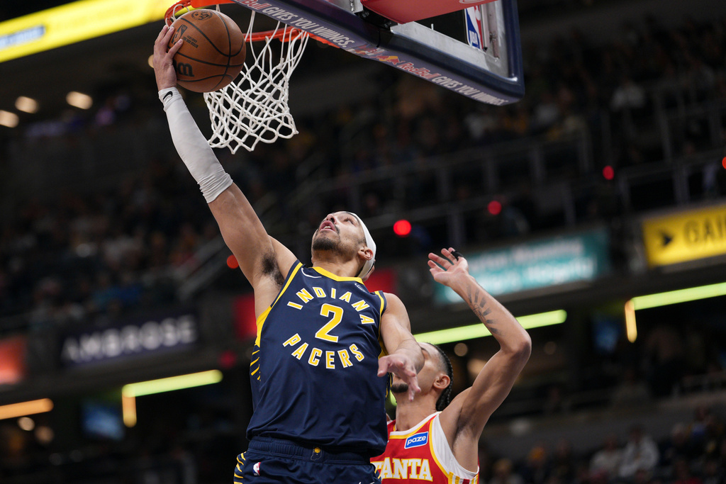 Indiana Pacers guard Andrew Nembhard, left, shoots in front of Atlanta Hawks forward Zaccharie Risacher during the first half of an NBA basketball game in Indianapolis, Saturday, Jan. 31, 2026. (AP Photo/AJ Mast)