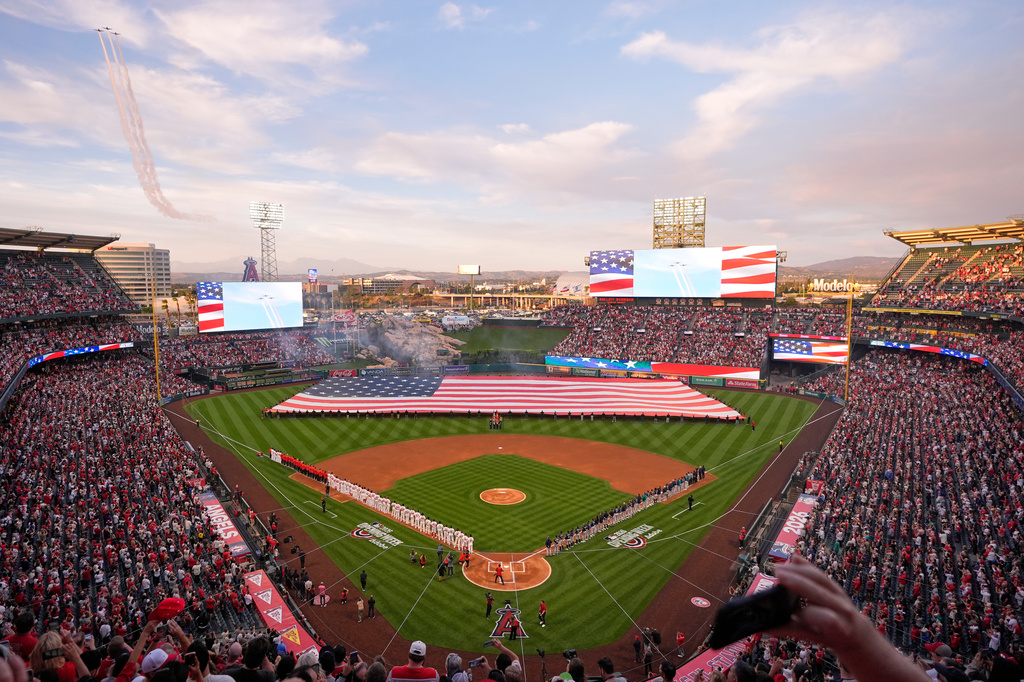 Three North American AT-6 Texan aircraft fly over during the national anthem prior to an opening-day baseball game between the Los Angeles Angels and the Seattle Mariners, Friday, April 3, 2026, in Anaheim, Calif. (AP Photo/Mark J. Terrill)
