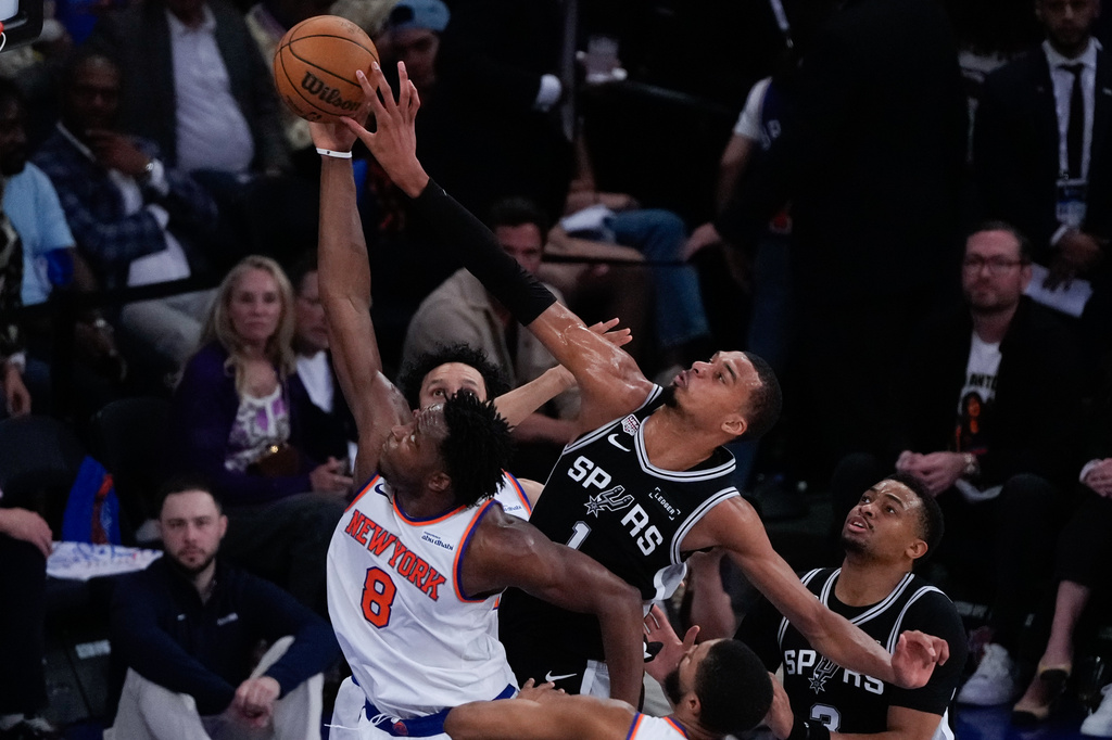 San Antonio Spurs forward Victor Wembanyama blocks the shot of New York Knicks forward Og Anunoby (8) during the first half of Game 4 of the NBA Finals basketball series, Wednesday, June 10, 2026, in New York. (AP Photo/Ross D. Franklin)
