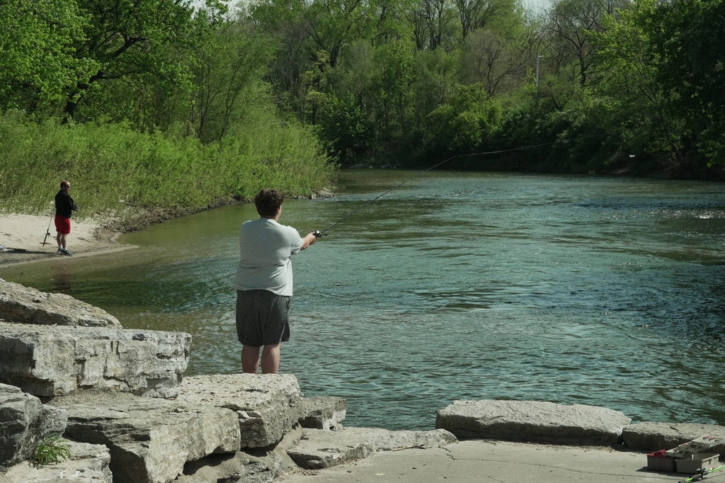 People fish along the Maquoketa River, Thursday, May 7, 2026, in Manchester, Iowa. (AP Photo/Brittany Peterson)