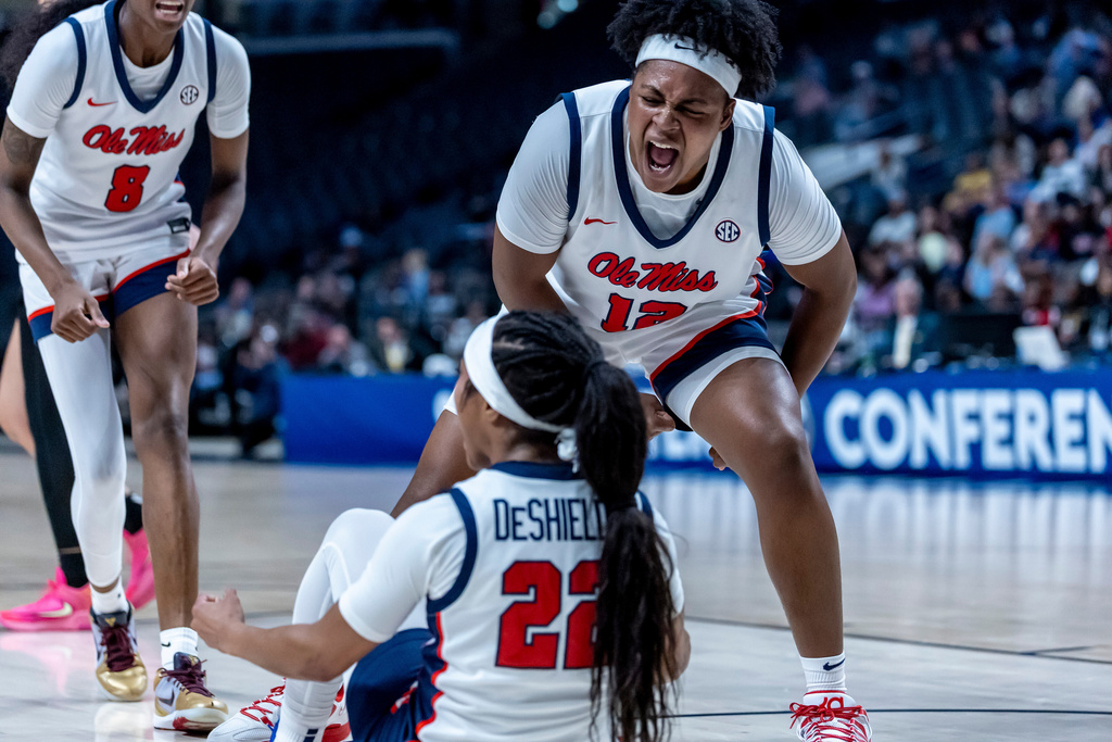 Mississippi forward Christeen Iwuala (12) cheers her teammate, guard Denim DeShields (22), after a collision during the first half of an NCAA college basketball game against Vanderbilt, Friday, Jan. 30, 2026, in Birmingham, Ala. (AP Photo/Vasha Hunt)