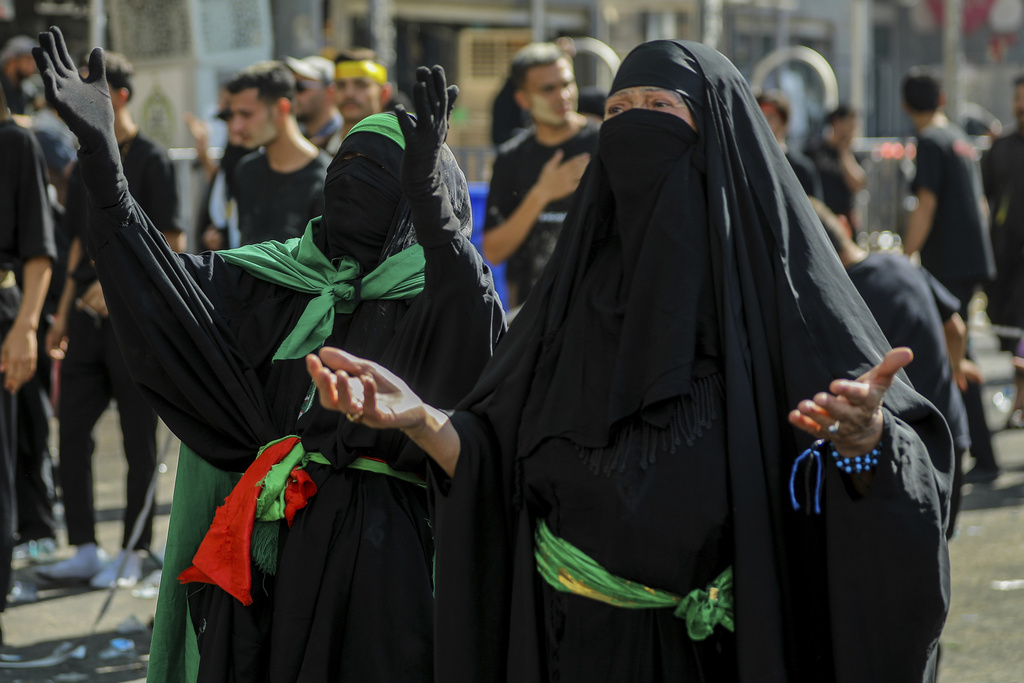 Shiite pilgrims women pray during Arbaeen, which marks the end of the 40-day mourning period following Ashoura, in Karbala, Iraq, Thursday, Aug. 14, 2025. (AP Photo/Ammar Khalil)