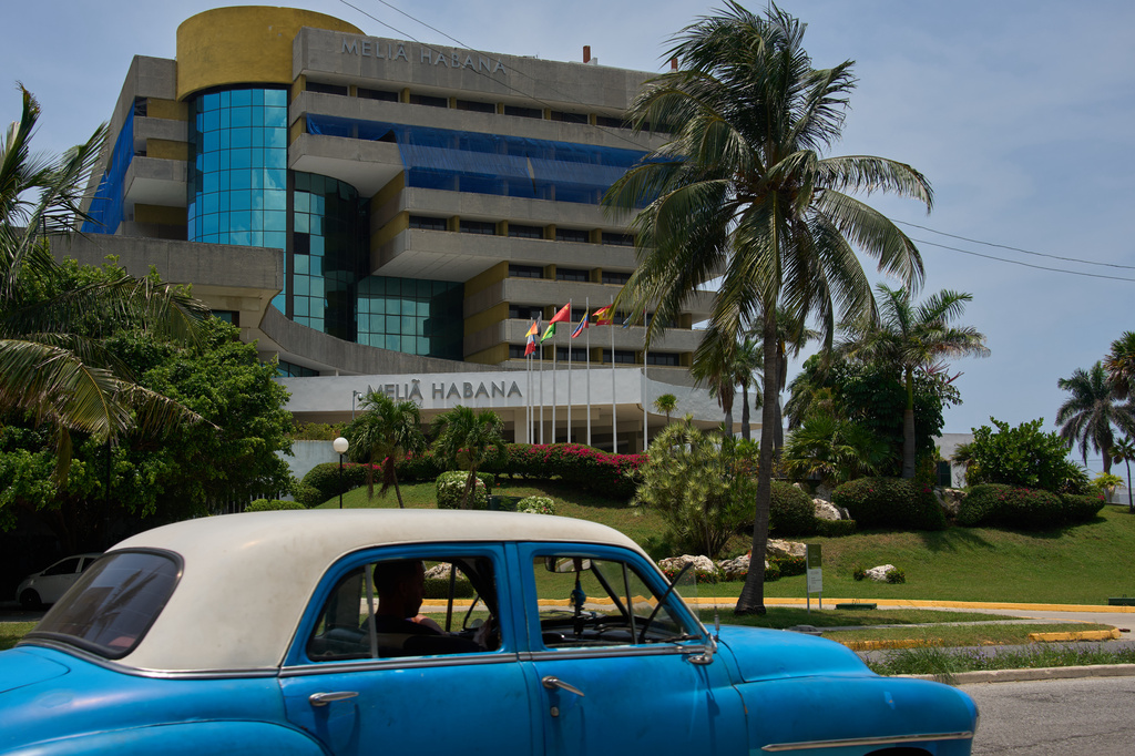 An antique car drives past the Melia Habana Hotel in Havana, Cuba, Tuesday, July 21, 2026. (AP Photo/Ramon Espinosa)