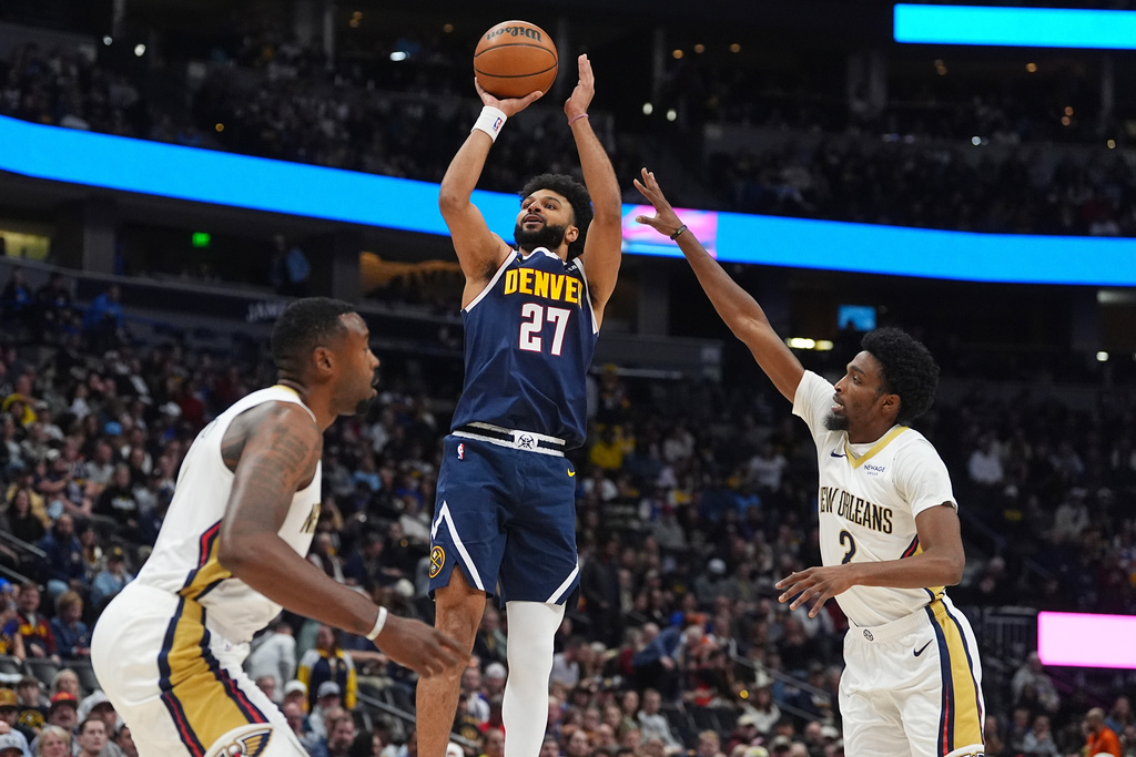 Denver Nuggets guard Jamal Murray, center, goes up for a basket between New Orleans Pelicans center DeAndre Jordan, left, and forward Herbert Jones in the first half of an NBA basketball game Wednesday, Oct. 29, 2025, in Denver. (AP Photo/David Zalubowski)