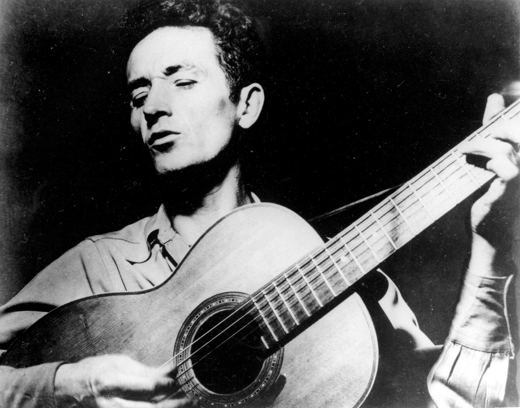 FILE - In this undated photo Oklahoma folk singer Woody Guthrie plays his guitar. (AP Photo, File)