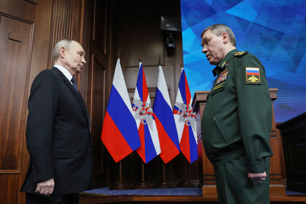 Russian Chief of General Staff Gen. Valery Gerasimov, right, reports to Russian President Vladimir Putin at the annual board meeting of the Russian Defense Ministry and award soldiers in Moscow, Wednesday, Dec. 17, 2025. (Alexander Kazakov/Sputnik, Kremlin Pool Photo via AP)
