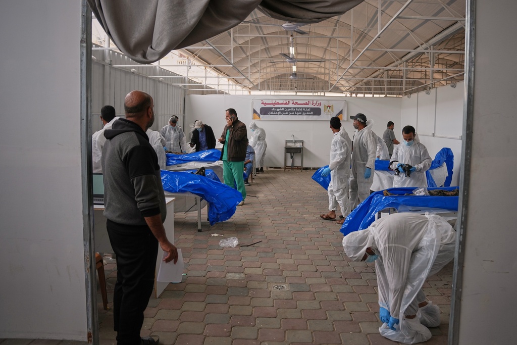 Forensic staff receives bodies of unidentified Palestinians returned from Israel at a facility in Nasser Hospital in Khan Younis, Gaza Strip, Friday, Nov. 14, 2025. (AP Photo/Abdel Kareem Hana)