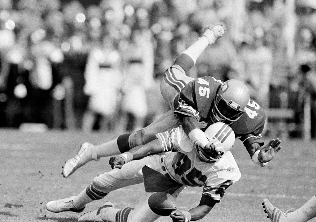 FILE - Seattle Seahawks safety Kenny Easley (45) tries to break up a Miami Dolphins pass to Mark Duper (85) but Duper held on only to drop the ball momentarily but finally kept possession during an NFL playoff football game in Miami, Dec. 29, 1984. (AP Photo/Raul Demolina, File)