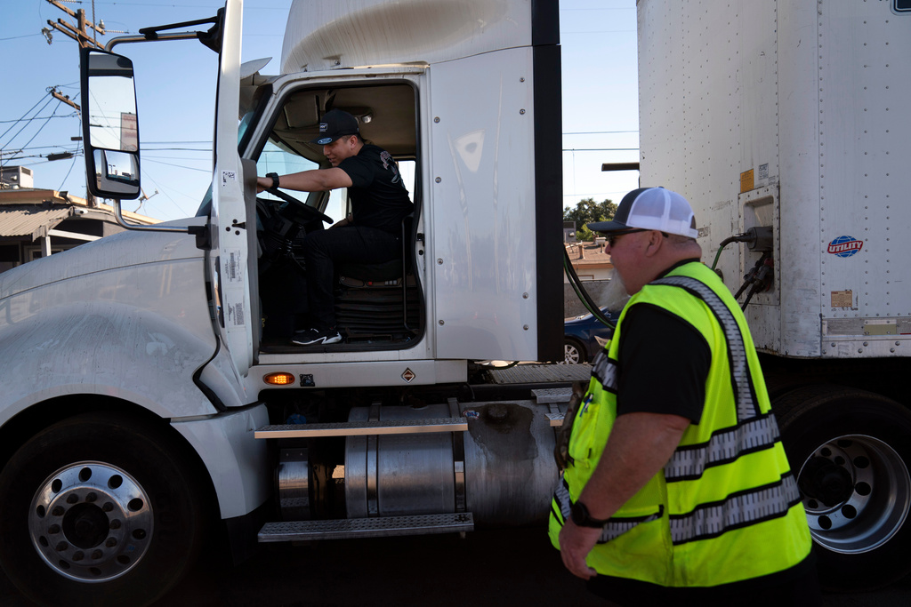 FILE - A student driver gets on a truck as the instructor watches in Calif., Nov. 15, 2021. (AP Photo/Jae C. Hong, File)