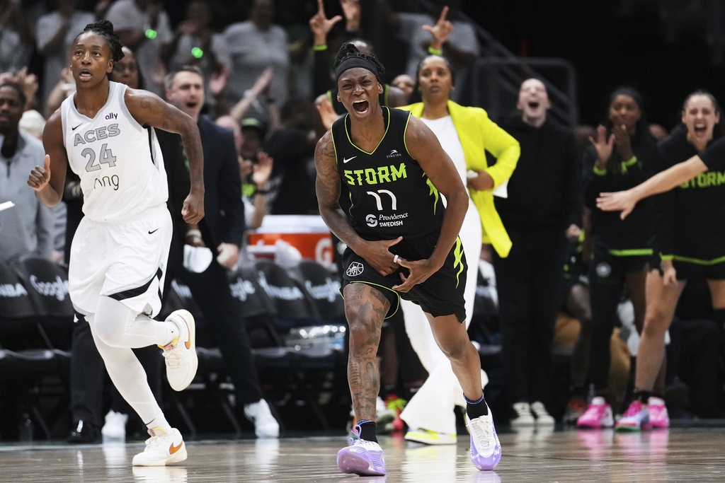 Seattle Storm guard Erica Wheeler (17) reacts after a basket as Las Vegas Aces guard Jewell Loyd (24) looks on during the second half of Game 2 in the first round of the WNBA basketball playoffs Tuesday, Sept. 16, 2025, in Seattle. (AP Photo/Lindsey Wasson)