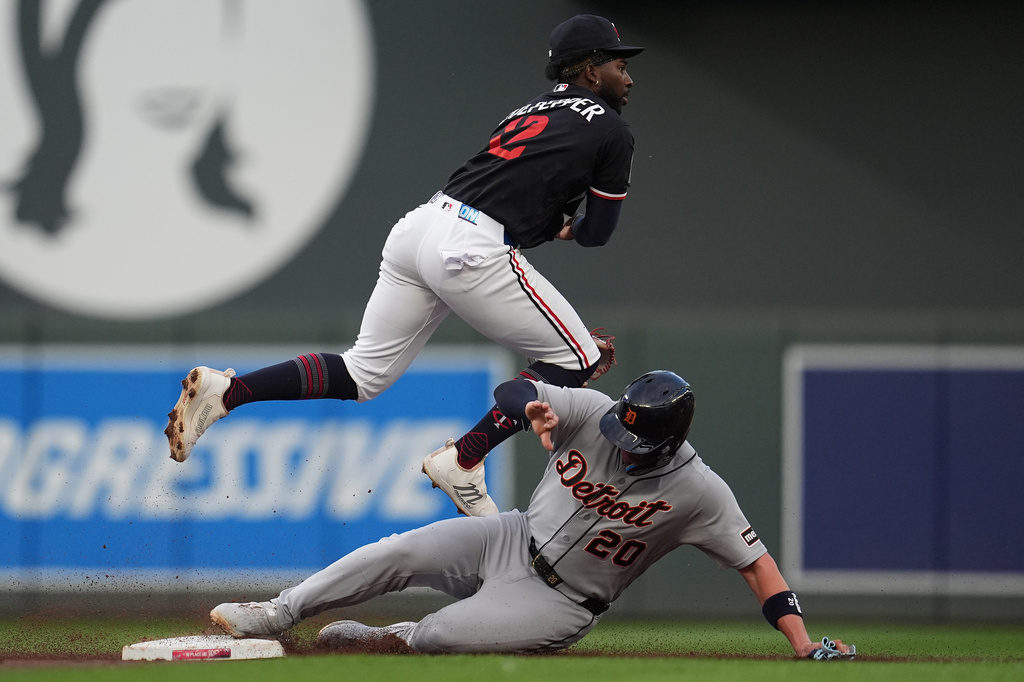 Minnesota Twins shortstop Kaelen Culpepper top, leaps over Detroit Tigers' Spencer Torkelson (20) while trying to complete a double play during the third inning of a baseball game Monday, Aug. 31, 2026, in Minneapolis. (AP Photo/Abbie Parr) CORRECTION: Corrects to third inning not second inning.