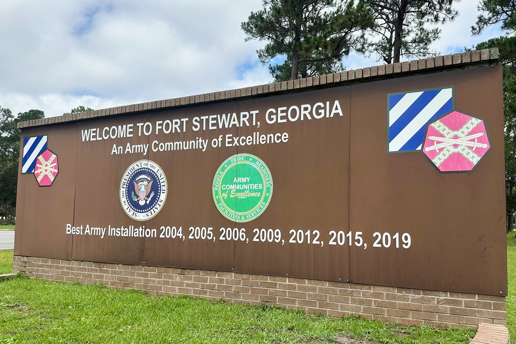 FILE - A sign stands outside the main gate of Fort Stewart, Ga., Aug. 6, 2025. (AP Photo/Russ Bynum, File)