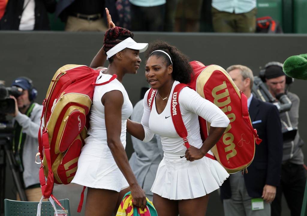 FILE -Serena Williams, right, and her sister Venus of the U.S celebrate after winning their women's doubles match against Andreja Klepac and Katarina Srebotnik of Slovenia on day four of the Wimbledon Tennis Championships in London, June 30, 2016. (AP Photo/Tim Ireland), File)