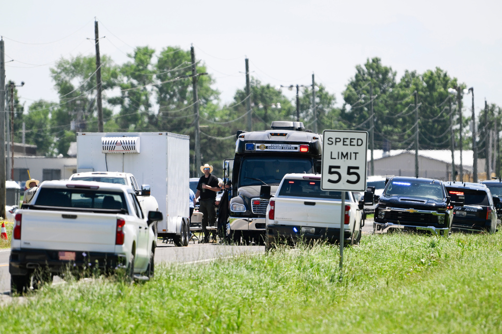 Emergency vehicles parked outside the Butler Memorial Airport after a plane crash in Butler, Mo., Sunday, June 14, 2026. (AP Photo/Reed Hoffmann)