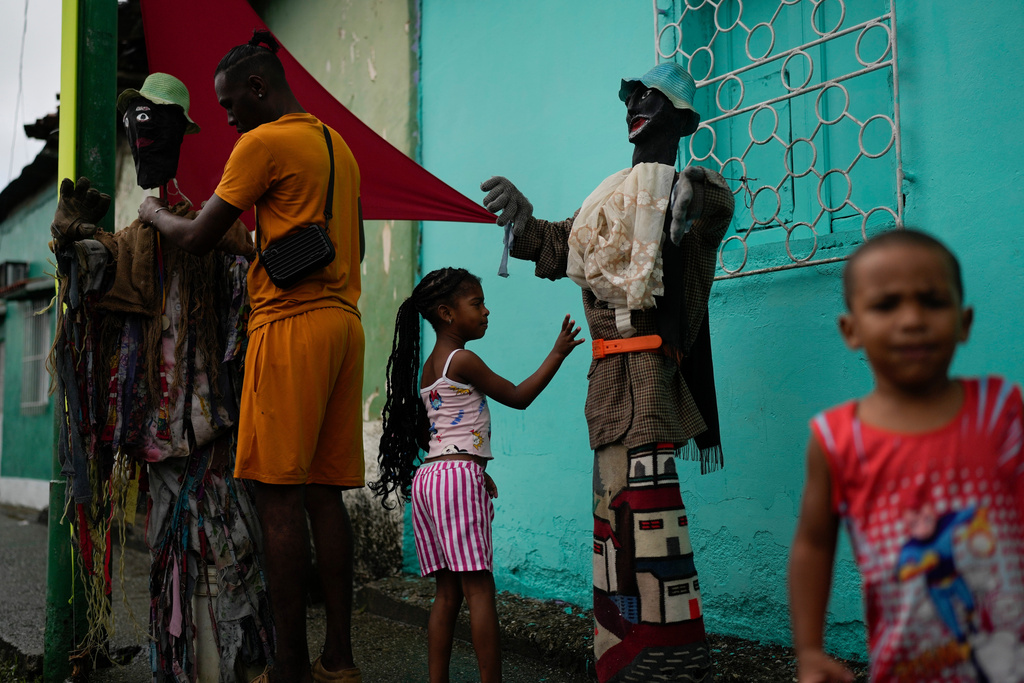 Revelers take part in the Afro-Venezuelan Holy Innocents' Day celebration in Caucagua, Venezuela, Sunday, Dec. 28, 2025. (AP Photo/Matias Delacroix)