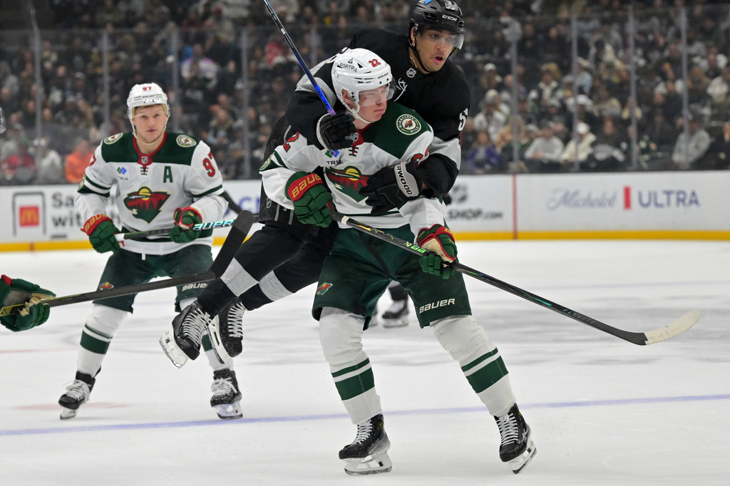 Los Angeles Kings right wing Quinton Byfield collides with Minnesota Wild right wing Danila Yurov (22) during the second period of an NHL hockey game, Saturday, Jan. 3, 2026, in Los Angeles. (AP Photo/Jayne Kamin-Oncea)
