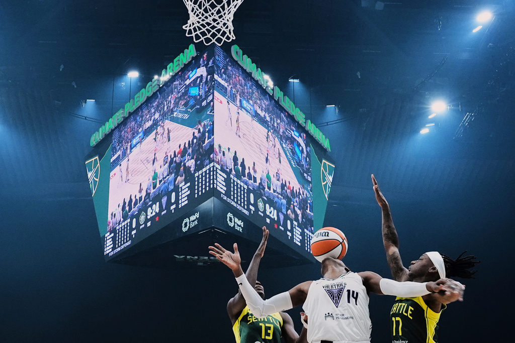 Golden State Valkyries center Temi Fagbenle (14) loses the ball against Seattle Storm forward Ezi Magbegor (13) and guard Erica Wheeler, right, during the first half of a WNBA basketball game, July 16, 2025, in Seattle. (AP Photo/Lindsey Wasson, File)