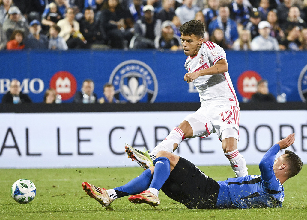 CF Montreal's Fabian Herbers, bottom, slides in on St. Louis City's Celio Pompeu (12) during the second half of a MLS soccer game in Montreal on Saturday, Sept. 13, 2025. (Graham Hughes/The Canadian Press via AP)
