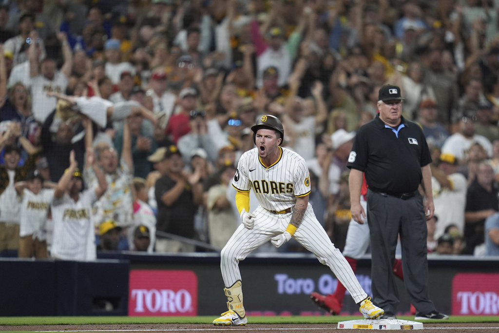 San Diego Padres' Jackson Merrill celebrates after hitting a two-RBI triple during the sixth inning of a baseball game against the Cincinnati Reds Monday, Sept. 8, 2025, in San Diego. (AP Photo/Gregory Bull)