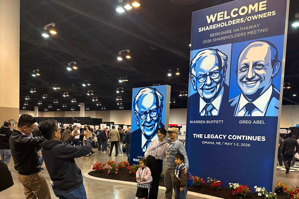 Shareholders line up to take pictures with depictions of Berkshire Hathaway's new CEO Greg Abel and Chairman Warren Buffett on Friday, May 1, 2026 in Omaha, Neb. (AP Photo/Josh Funk)