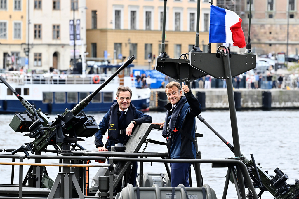 French President Emmanuel Macron, right, and Swedish Prime Minister Ulf Kristersson board a combat boat 90, in Stockholm, Sweden, Monday, Aug. 31, 2026. (Pontus Lundahl /TT News Agency via AP)