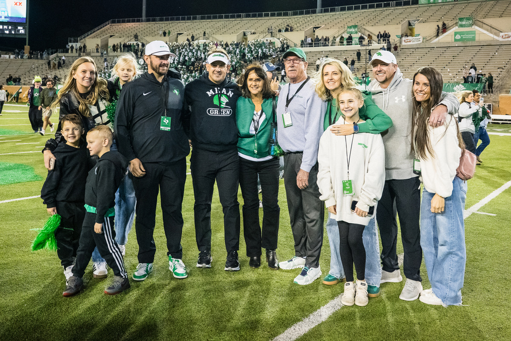 North Texas head coach Eric Morris, sixth from left, poses for a photo with his family after winning an NCAA college football game against Temple, Friday, Nov. 28, 2025, Denton, Texas. (AP Photo/Jessica Tobias)