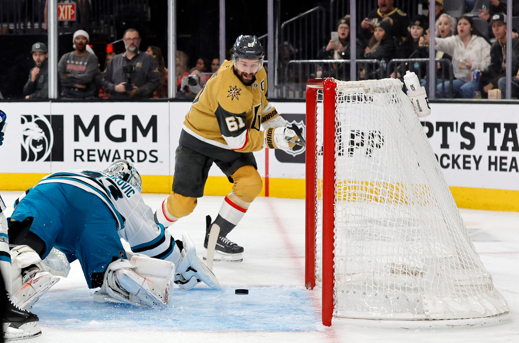 Vegas Golden Knights right wing Mark Stone (61) takes a shot against San Jose Sharks goaltender Alex Nedeljkovic (33) during the second period of an NHL hockey game Tuesday, Dec. 23, 2025, in Las Vegas. (AP Photo/Steve Marcus)