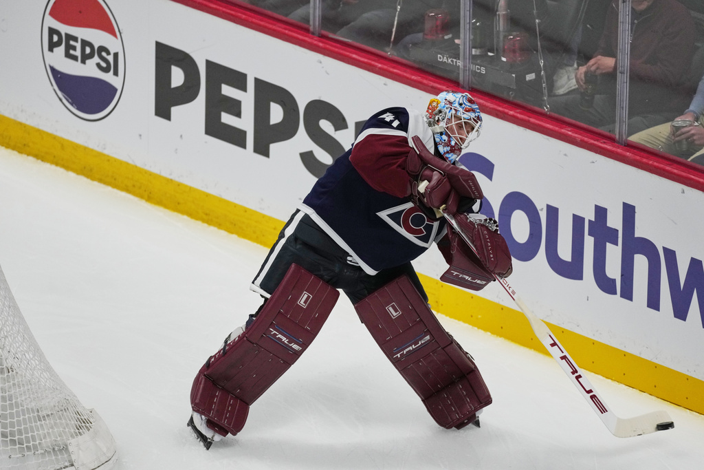 Colorado Avalanche goaltender Scott Wedgewood clears the puck in the first period of an NHL hockey game against the Dallas Stars, Wednesday, March 18, 2026, in Denver. (AP Photo/David Zalubowski)