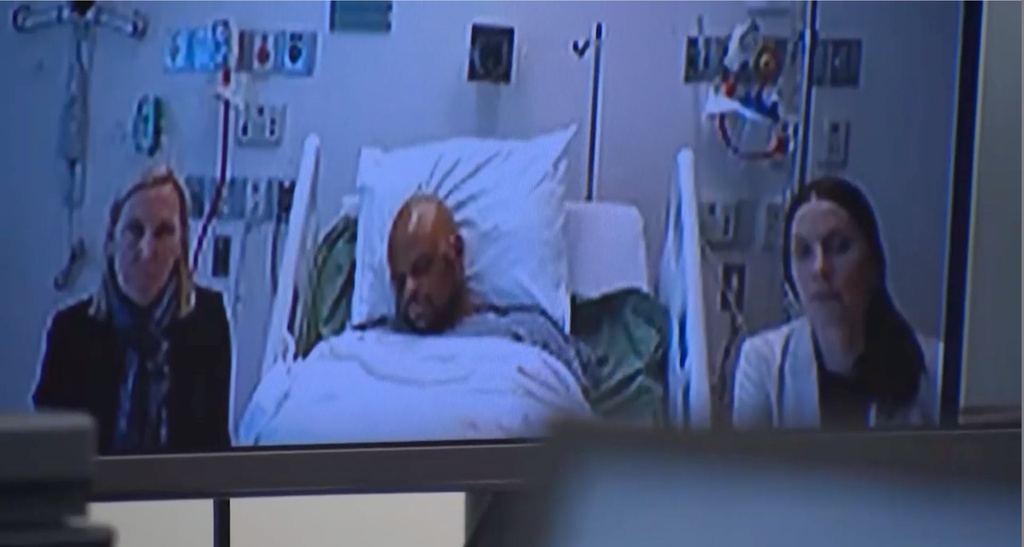This image provided by Cambridge District Court, Tyler Brown appears in court via zoom from a hospital bed on Thursday, May 14, 2026 in Cambridge, Mass. (Cambridge District Court via AP)