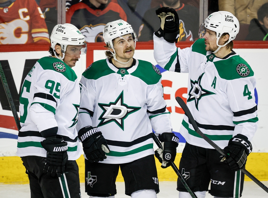 Dallas Stars' Sam Steel, center, celebrates his goal with teammates Matt Duchene, left, and Miro Heiskanen during the second period of an NHL hockey game against the Calgary Flames in Calgary, Alberta on Tuesday, March 3, 2026. (Jeff McIntosh/The Canadian Press via AP)
