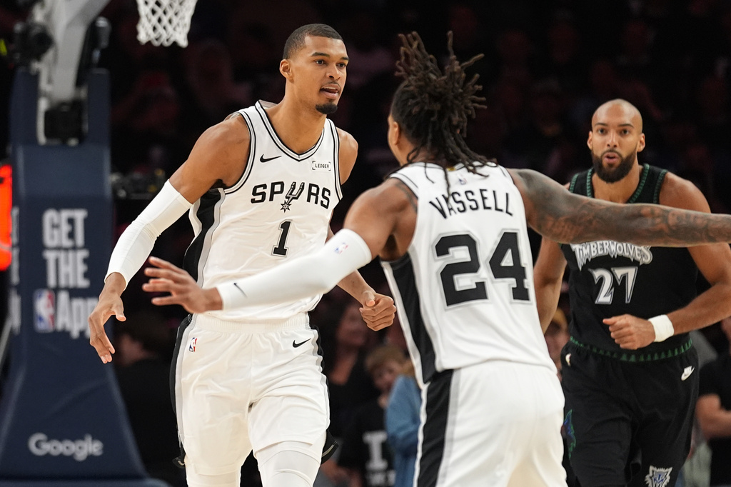 San Antonio Spurs forward Victor Wembanyama (1) celebrates a score against the Minnesota Timberwolves with teammate guard Devin Vassell (24) during the first half of Game 3 of a NBA basketball second-round playoff series in Minneapolis, Friday, May 8, 2026. (AP Photo/Abbie Parr)