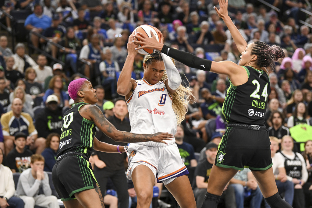 Phoenix Mercury forward Satou Sabally (0) is boxed in by Minnesota Lynx guard Courtney Williams, left, and forward Napheesa Collier (24) during the first half of Game 1 of a WNBA basketball playoff semifinals series Sunday, Sept. 21, 2025, in Minneapolis. (AP Photo/Craig Lassig)