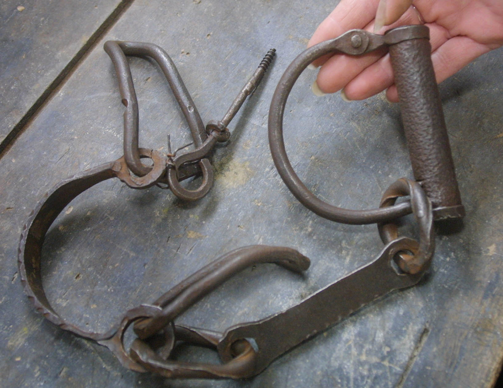FILE — Donna Coburn displays slave shackles at the John Brown Museum on her farm in Guys Mills, Pa., on March 14, 2002. (AP Photo/Gary Tramontina, File)