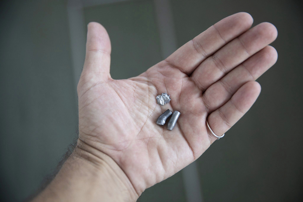 A member of the MV Ocean Viking, search and rescue vessel chartered by non profit group nonprofit SOS Mediterranee, shows bullets which, according to the organisation, were fired on its vessel by the Libyan Coast Guard, approximately 40 Nautical Miles north of the Libyan coast, Sunday, Aug. 24, 2025. (Max Cavallari/SOS Mediterranee Via AP)
