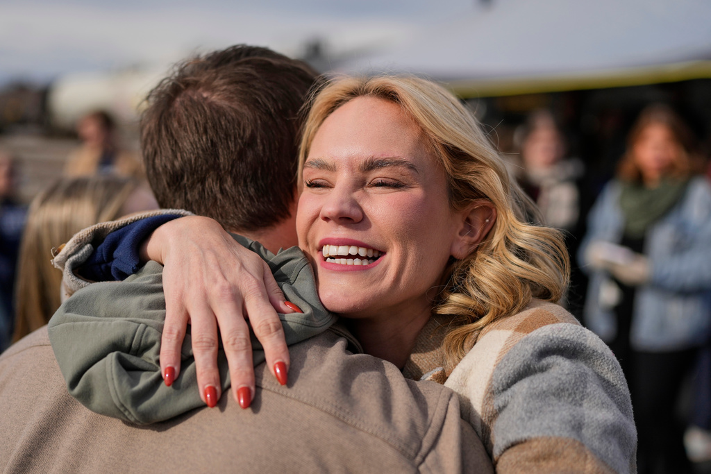 Democratic congressional candidate and state Rep. Aftyn Behn, D-Nashville, hugs a supporter during a campaign event in the special election for the seventh district Saturday, Nov. 29, 2025, in Nashville, Tenn. (AP Photo/George Walker IV)