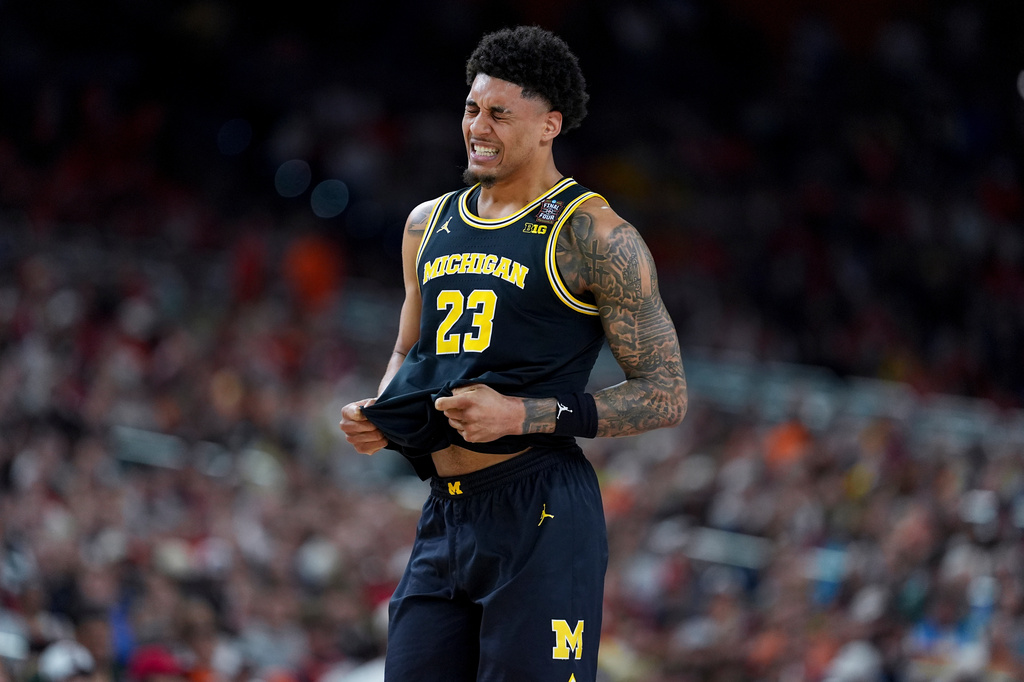 Michigan forward Yaxel Lendeborg reacts after an injury on the court during the first half of an NCAA college basketball tournament semifinal game against Arizona at the Final Four, Saturday, April 4, 2026, in Indianapolis. (AP Photo/Abbie Parr)