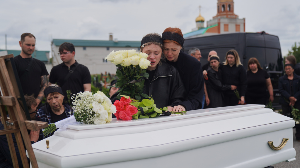 People mourn over the coffin of Oleksandra Bardadym, 20, who was killed in Russia's recent missile attack in Kyiv, Ukraine, Wednesday, July 8, 2026. (AP Photo/Oleksandr Khomenko)